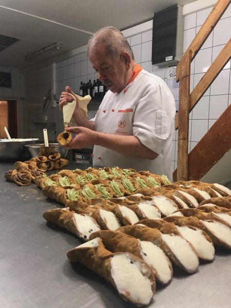 Giovanni est occupé à remplir le cannolo au chocolat.